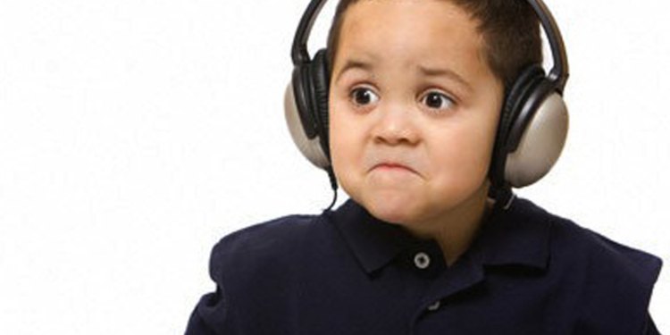 B4663K Sad boy with headphones not liking song choice