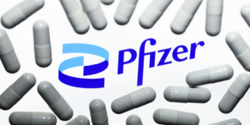 Pfizer logo displayed on a laptop screen and medical pills are seen in this illustration photo taken in Krakow, Poland on October 18, 2021. (Photo by Jakub Porzycki/NurPhoto via Getty Images)